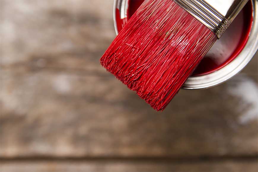 red paint and a brush